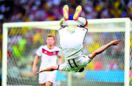 Klose does his trademark front flip after scoring second goal.