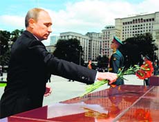 Russian President Vladimir Putin lays flowers at one of the sites of the major Red Army battles of World War II near the Tomb of the Unknown Soldier in Moscow on Sunday