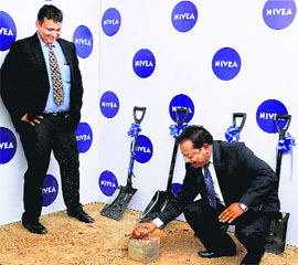 Nivea managing director Rakshit Hargave breaks a coconut at the ground-breaking ceremony for the company's first manufacturing plant in India at Sanand, Gujarat, on Monday.