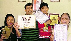 Mathematics lecturer Sandeep Tripathi shows his certificates
