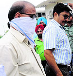 Yograj Talwar, senior accountant of Markfed, with the vigilance team on Monday