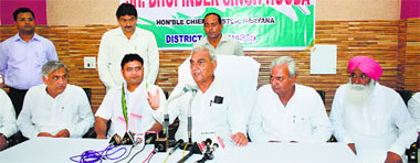 Chief Minister Bhupinder Singh Hooda (right) talks to the media in Fatehabad on Monday. State Congress chief Ashok Tanwar looks on. Tribune photograph