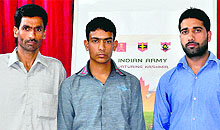 Fayaz Ahmed Dar (centre) with his father (left) and teacher in Srinagar