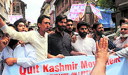The police detain chairman of the Jammu & Kashmir Liberation Front Yasin Malik along with party activists when they tried to take out a procession towards Lal Chowk in Srinagar on Monday