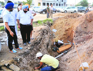 MC and PSPCL officials inspect the site on Ferozepur Road where illegal digging was carried out.
