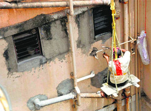 A BMC employee disconnects the water supply to the Campa Cola Society in Mumbai on Monday.