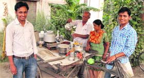 Amit and Sumit, who have cleared the IIT-JEE, with their father at his tea stall in Jalandhar.