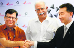 Civil Aviation Minister Ashok Gajapathi Raju looks on as Air India CMD Rohit Nandan (L) and Star Alliance COO Jeffrey Goh shake hands during the announcement of Air India's joining of Star Alliance, in New Delhi on Tuesday. PTI