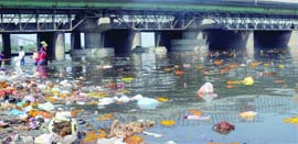 A view of the Yamuna near ITO, where people have thrown articles after religious festivals. 