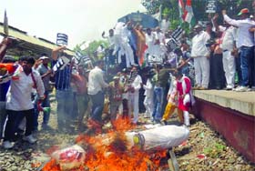 Activists of the DPCC stop train as they protest against price hike of rail fare and the power and water crises in Delhi at Palam in South Delhi on Tuesday. 