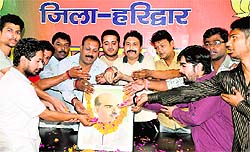 BJP activists offer floral tributes to Jan Sangh founder Shyama Prasad Mookerjee at the party office in Haridwar on Tuesday.