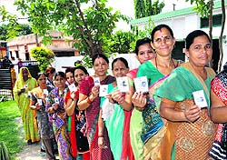 Women line up to vote in the third phase of the panchayat polls in the Doiwala block of Dehradun district on Tuesday.