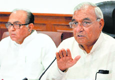 Chief Minister Bhupinder Singh Hooda talks to the media in Chandigarh on Tuesday. Power Minister Capt Ajay Yadav looks on.