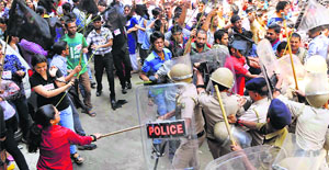 Activists of the SFI clash with policemen during a protest against fee hike on Himachal Pradesh University campus in Shimla on Tuesday.
