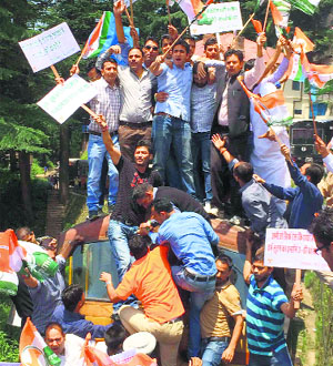 Activists of the YC stop a toy train during a protest against the hike in rail fares in Shimla on Tuesday.