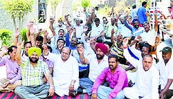 Resident stage a dharna outside the Surya Enclave police post on Tuesday. 