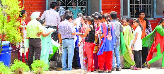 Students and parents wait for their turn to submit forms at the Government College for Girls in Ludhiana.