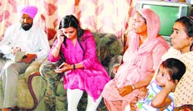 Jaraon SDM Apneet Rayat speak to one of the youths over the phone in the presence of his family members on Tuesday.