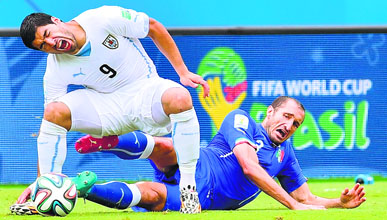 Uruguays Luis Suarez (L) was in the eye of storm after he bit Italy's defender Giorgio Chiellini during the Group D match at the Dunas Arena in Natal on Tuesday.