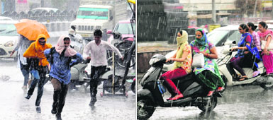 Commuters get caught in a sudden spell of rain near Fauji Chowk in Bathinda on Wednesday.