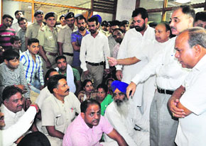 Mayor Harphool Chander Kalyan (third from right) was busy pacifying protesting Congress councillors who sat on a dharna in front of the Chief Engineers office with area residents at the MC office in Sector 17, Chandigarh, on Wednesday.