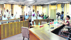 BJP councillors raise hands during the passing of resolutions as Senior Deputy Mayor Heera Negi chairs the House meeting in Sector 17 on Wednesday.