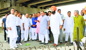 Minister of State for Road Transport, Highways and Shipping Krishan Pal Gujjar (centre, in blue jacket) and officials of NHAI inspect construction work of the National Highway in Karnal on Wednesday.
