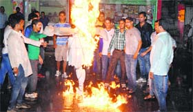 Youth Congress activists burn an effigy of Prime Minister Narendra Modi at Dharamsala on Wednesday.