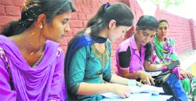 Admission seekers fill application forms at Government Degree College, Parade, in Jammu.