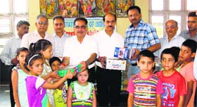 Officials of the State Bank of India distributes utility articles among inmates of Bal Niketan in Jammu on Thursday.