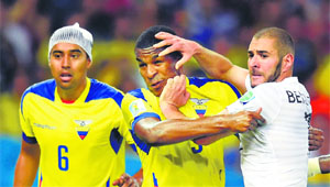 France's Karim Benzema (R) and Ecuador's Frickson Erazo (C) get physical during their Group E match on Wednesday.