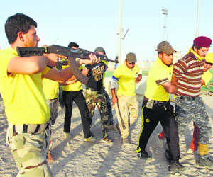 Shiite volunteers, who have joined the Iraqi army to fight against the predominantly Sunni militants from the radical ISIL, take part in a military-style training in Basra.