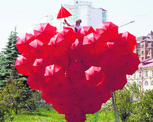 A Russian artist shows his artwork, which consists of about 80 umbrellas, on the eve of the opening of a music festival in the Siberian city of Krasnoyarsk on Thursday.