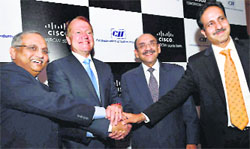 Cisco Systems chairman John T. Chambers with CII president Ajay S. Shriram, CII DG Chandrajit Banerjee and Cisco India president Dinesh Malkani at a meeting in New Delhi on Friday. PTI