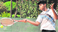 Aniket returns a shot during the U-18 final match of Swami Ram Tirath Total Tennis Championship played in Mohali on Friday. Tribune photo: Parvesh Chauhan
