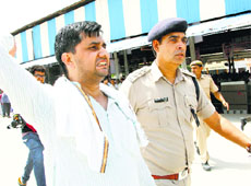 Yogesh Sihag, the leaders of the protesters, is taken away by a police officer in Hisar on Friday.