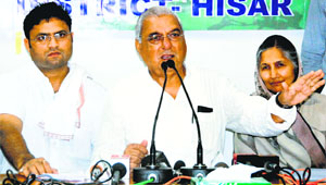 Chief Minister Bhupinder Singh Hooda addresses the media in Hisar on Friday. State Congress chief Ashok Tanwar  and Urban Local Bodies Minister Savitri Jindal look on.