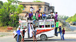 An overloaded minibus near the Jagti Road in Jammu on Friday. Tribune photo: Inderjeet Singh