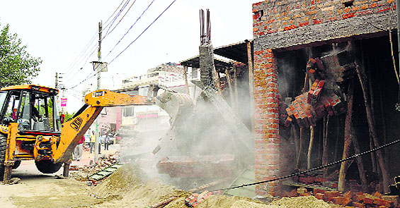 (top) the building is demolished at Kochar Market in Ludhiana on Friday. 