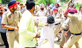 Policemen beat up a protester in Bhawanigarh, Sangrur, on Friday.