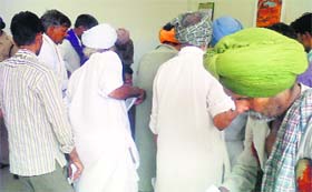 Patients collect medicines at the drug de-addiction centre in Civil Hospital, Bathinda, on Friday.