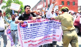 Kashmiri Pandits protest the government for its failure to fulfil their six-point charter of demands, including passing of the shrine Bill, in Srinagar.