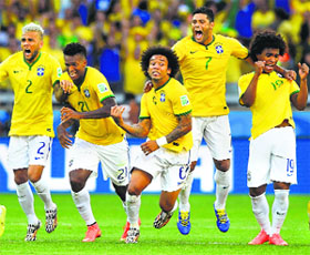 Brazil soccer players celebrate after the decisive goal during a penalty shootout against Chile at the Mineirao stadium in Belo Horizonte on Saturday.