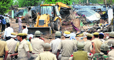 An earthmoving machine removes illegal shanties during an anti-encroachment drive at Gandhi Colony of the Mansa Devi Complex, Panchkula, on Sunday. Tribune Photos: Nitin Mittal