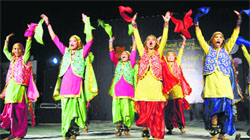 Girls perform during Punjabi Folk Music, Tribal Dance and Food Festival organised by the North Zone Cultural Centre, Patiala, at the Kalagram in Mani Majra, Chandigarh, on Sunday. Tribune photo: Vicky Gharu
