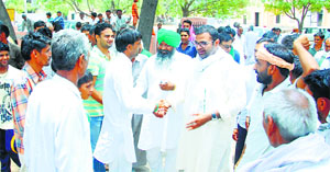 Residents receive Karan Singh Chautala and Charanjit Singh Rori during their visit to Kirdhan village in Fatehabad on Sunday.