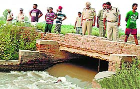 Police officials at the spot where the body was spotted
