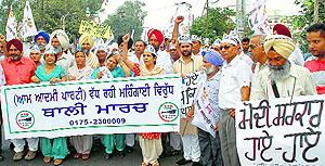 Aam Aadmi Party (AAP) workers hold a protest against inflation in Patiala on Sunday
