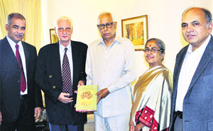 Governor NN Vohra being presented a copy of the book The Languages of Jammu and Kashmir at Raj Bhawan in Srinagar on Monday.