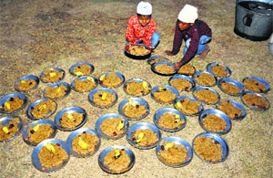 Children arrange plates filled with eatables for a community meal on the first day of Ramadan at Ziarat Baba Ibrahim Sahib in Jammu on Monday.